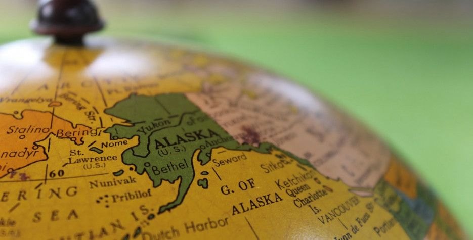 Antique globe with Alaska in focus, including Nome, Bethel, Seward, Sitka, and the Bering Sea